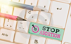 Text sign showing Stop Abortion. Conceptual photo advocating against the practice of abortion Prolife movement White pc