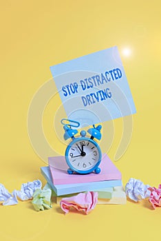 Text sign showing Stop Distracted Driving. Conceptual photo asking to be careful behind wheel drive slowly Alarm clock
