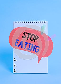 Text sign showing Stop Eating. Conceptual photo cease the activity of putting or taking food into the mouth Spiral