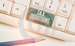 Text sign showing Tax Deductions. Conceptual photo an amount or cost that subtracted from someone s is income White pc