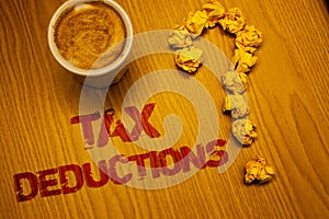 Text sign showing Tax Deductions. Conceptual photo Reduction on taxes Investment Savings Money Returns Words written Desk Coffee W