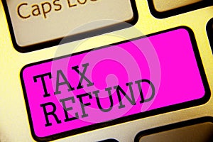 Text sign showing Tax Refund. Conceptual photo applied when money liability is less than the paid ones Keyboard purple key Intenti