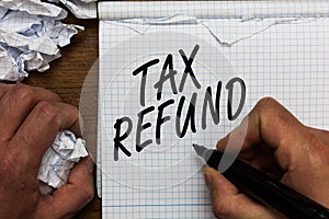 Text sign showing Tax Refund. Conceptual photo applied when money liability is less than the paid ones Man holding marker notebook