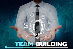 Text sign showing Team Building. Internet Concept Types of activities used to enhance social relations Businessman in