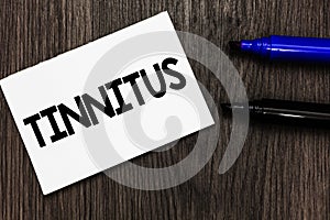 Text sign showing Tinnitus. Conceptual photo A ringing or music and similar sensation of sound in ears Important idea ideas notebo