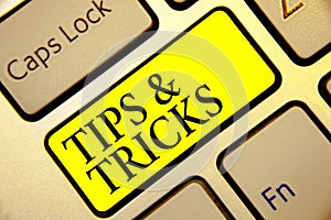 Text sign showing Tips and Tricks. Conceptual photo Steps Lifehacks Handy advice Recommendations Skills Keyboard yellow key Intent photo