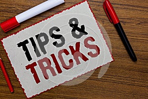 Text sign showing Tips and Tricks. Conceptual photo Steps Lifehacks Handy advice Recommendations Skills White paper red borders ma photo