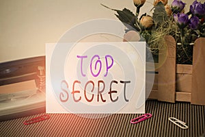 Text sign showing Top Secret. Conceptual photo telling someone important data or information that he cant tell Flowers