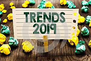 Text sign showing Trends 2019. Conceptual photo Upcoming year prevailing tendency Widely Discussed Online Clothespin holding noteb