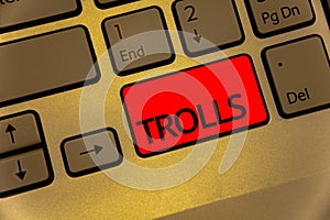 Text sign showing Trolls. Conceptual photo Online troublemakers posting provocative inflammatory messages Keyboard brown key yello photo