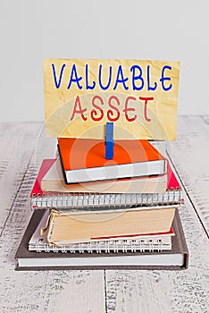 Text sign showing Valuable Asset. Conceptual photo Your most valuable asset is your ability or capacity pile stacked books photo