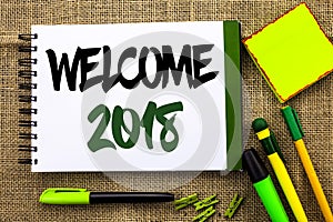 Text sign showing Welcome 2018. Conceptual photo Celebration New Celebrate Future Wishes Gratifying Wish written on Notebook Book photo