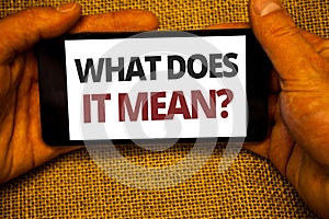 Text sign showing What Does It Mean Question. Conceptual photo Confusion Curiosity Questioning Inquire Jute sack background hand h