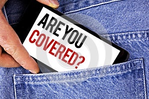 Text sign showing Are You Covered Question. Conceptual photo Health insurance coverage disaster recovery written on Mobile phone h