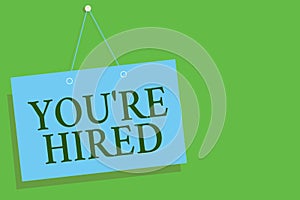 Text sign showing You re are Hired. Conceptual photo New Job Employed Newbie Enlisted Accepted Recruited Blue board wall message c