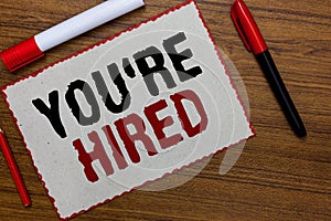 Text sign showing You re are Hired. Conceptual photo New Job Employed Newbie Enlisted Accepted Recruited White paper red borders m photo