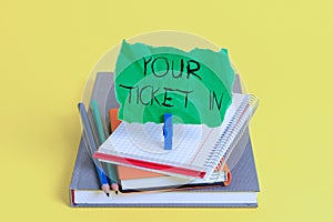 Text sign showing Your Ticket In. Conceptual photo piece of paper that prove you paid for service or show Book pencil