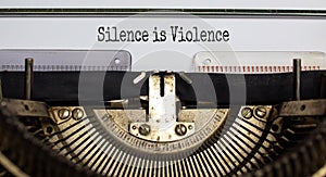 Text `silence is violence` typed on retro typewriter. Concept. Beautiful background photo