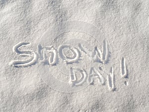 Text `Snow Day !` written in freshly fallen snow concept.