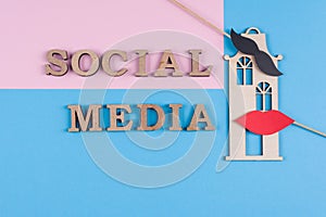 Text social media abstract wooden letters. Blue background with the image of house and pair of friends.