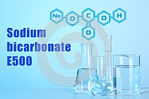 Text Sodium bicarbonate E500 with soda formula and laboratory glassware