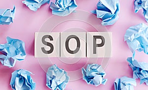 Text SOP on wooden cubes on a light background