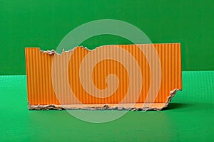text space copy background modern bright background green edges torn cardboard corrugated orange piece a