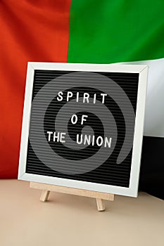 Text SPIRIT OF THE UNION on background flag of UAE. National holiday of United Arab Emirates. Commemoration Day Muslim