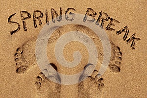 Text spring break in the sand of a beach