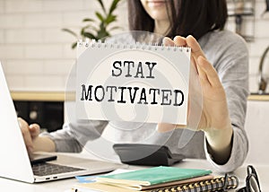 Text Stay motivated on white paper, business