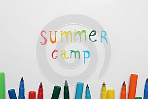 Text SUMMER CAMP and colorful felt tip pens on white paper