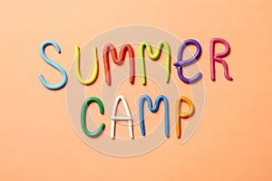 Text SUMMER CAMP made of modelling clay on color background