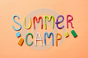 Text SUMMER CAMP made of modelling clay on color background