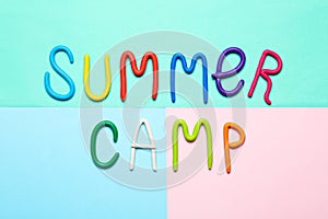 Text SUMMER CAMP made of modelling clay on color background