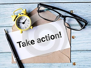 Text take action written on white paper