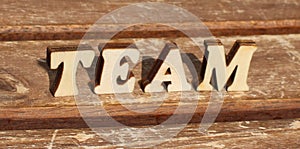 text TEAM from wooden letter alphabet in the sun on a sunny day