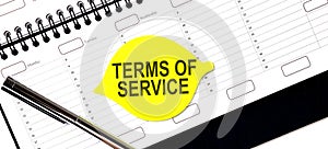 Text TERMS OF SERVICE on the yellow sticker on the planning