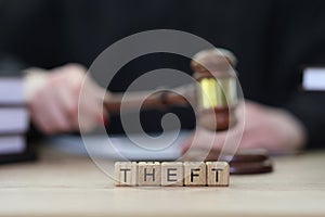 Text Theft and female judge knocking gavel at courtyard