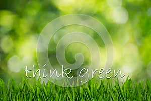 Text think green on green grass on blurred green bokeh background