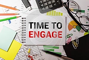 text TIME TO ENGAGE on the white short note paper yellow background