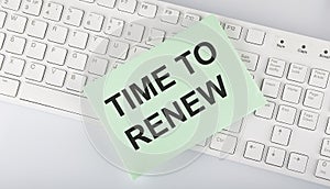 Text Time to Renew on envelope on keyboard on the white background