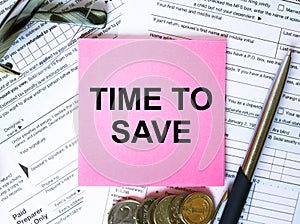 Text Time To Save on note paper with the U.S IRS 1040 form,pen and glasses