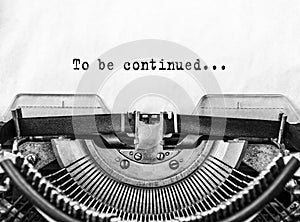 Text To be continued... typed words on a old Vintage Typewriter. photo