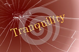 The text tranquility on the broken glass. Disorder or interfering concept