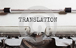 The text TRANSLATION is typed on paper by an antique typewriter. Vintage inscription, retro style, grunge, concept