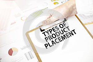 Text TYPES OF PRODUCT PLACEMENT on white paper plate in businessman hands with financial diagram. Business concept