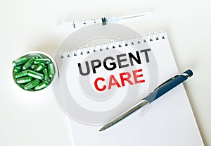 Text Upgent Care written in a notebook with a blue pen and a bunch of pills