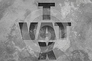 Text ` VAT ` TAX ` on old cement wall. Tariff wall concept