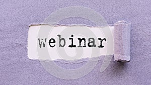 The text WEBINAR appears on torn lilac paper against a white background