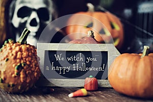 Text We witch you a happy Halloween in a chalkboard